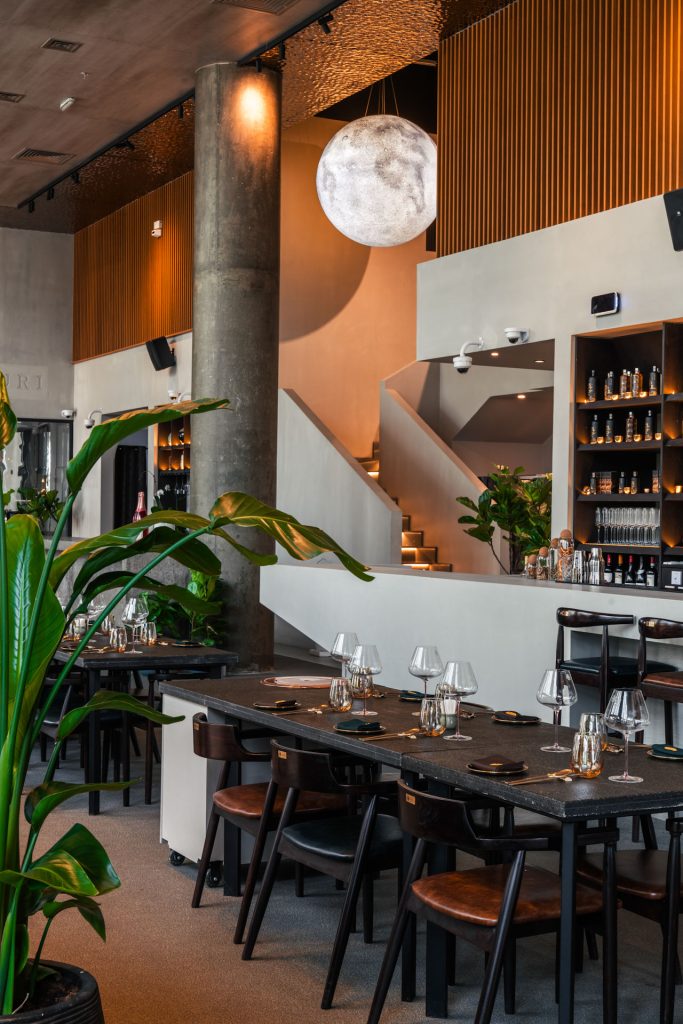 Portrait photo of dining table set and bar on the background
